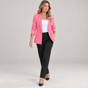 Women's slim-fit blazer with a tailored cut and lapels, worn by a female model in a walking pose