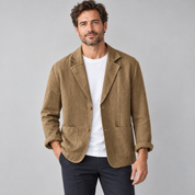 Men's casual blazer with wide lapels and pockets, worn by a male model, close-up