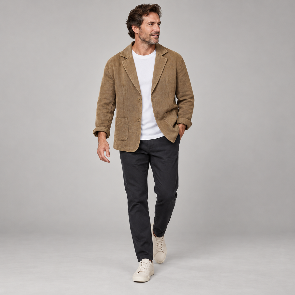 Men's casual blazer with wide lapels and pockets, worn by a male model in a walking pose
