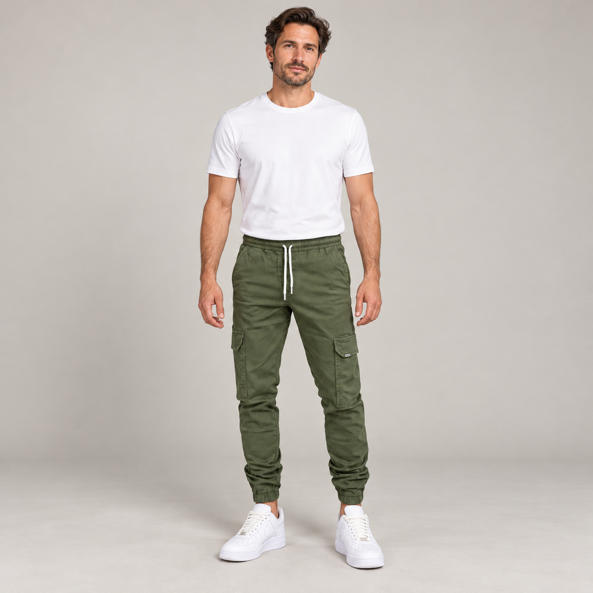 Men's durable slim-fit cargo trousers with deep pockets, worn by a male model, front view