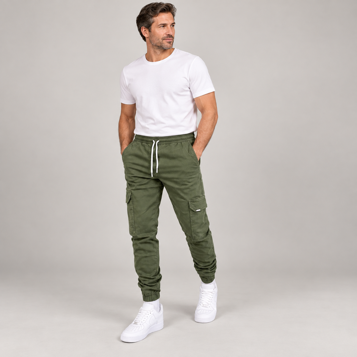 Men's durable slim-fit cargo trousers with deep pockets, worn by a male model, angled front view