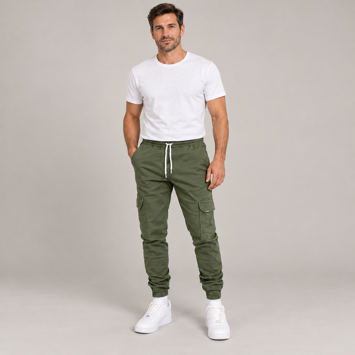 Men's durable slim-fit cargo trousers with deep pockets, worn by a male model, close-up