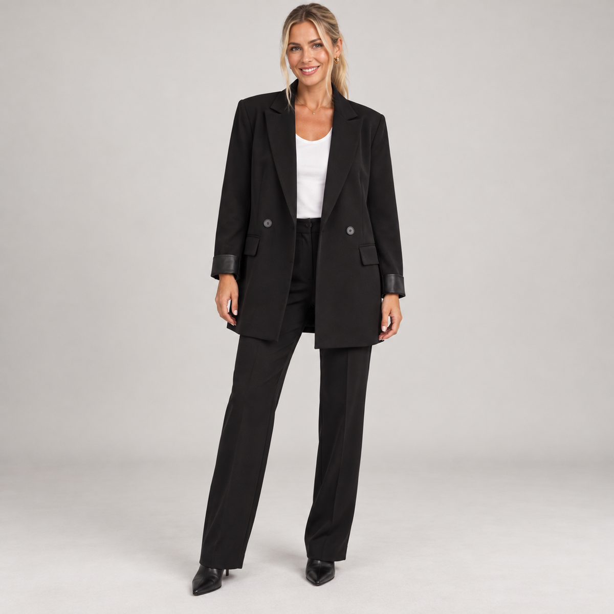 Women's black long oversized double-breasted blazer, worn by a female model, front view
