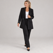 Women's black long oversized double-breasted blazer, worn by a female model in a walking pose