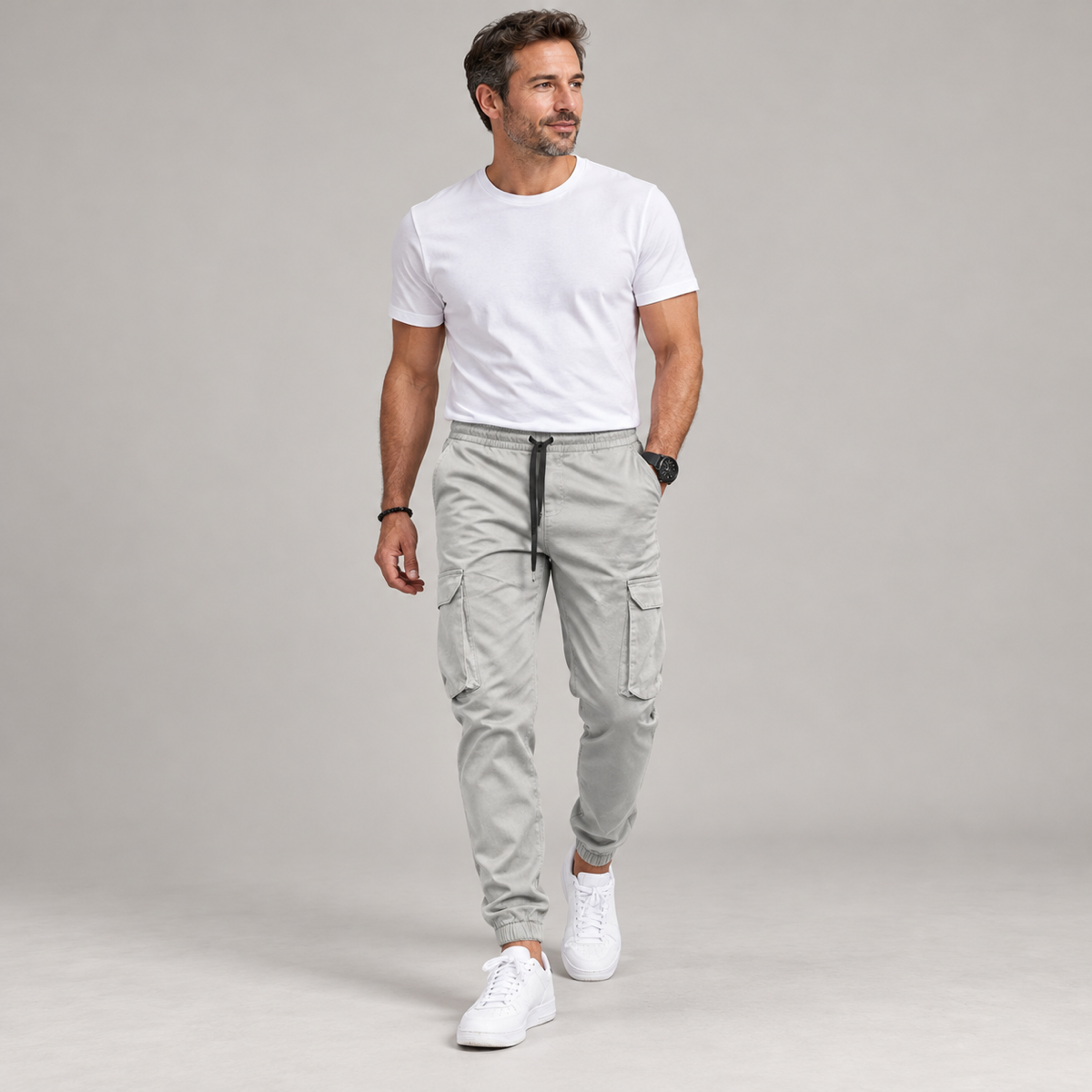 Men's slim-fit joggers with an elastic waistband, worn by a male model in a walking pose
