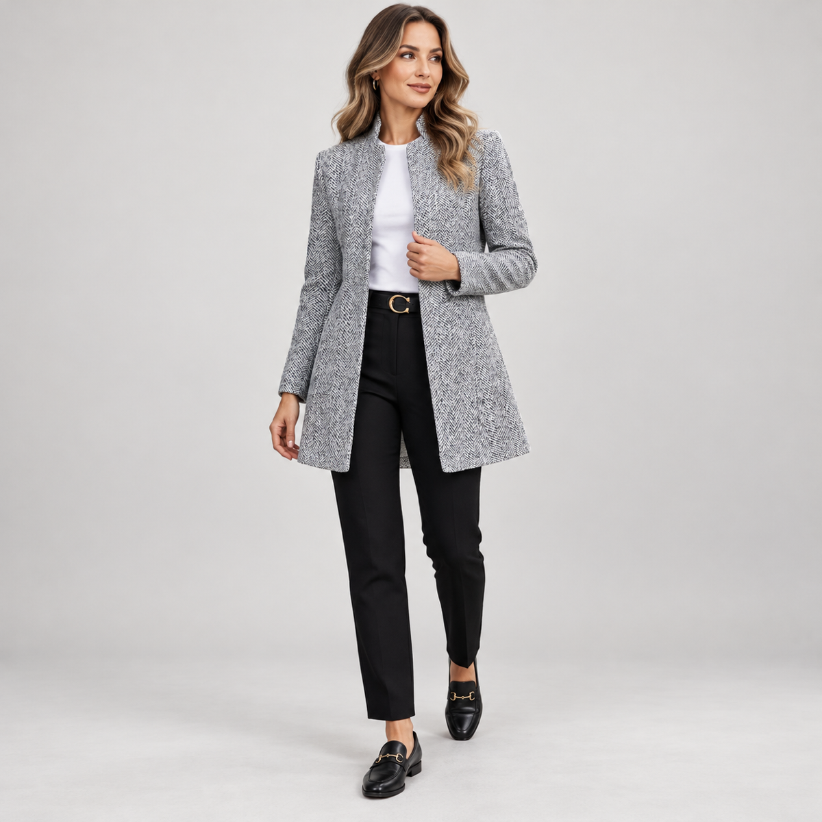 Women's long grey blazer with a stand-up collar, worn by a female model, angled front view
