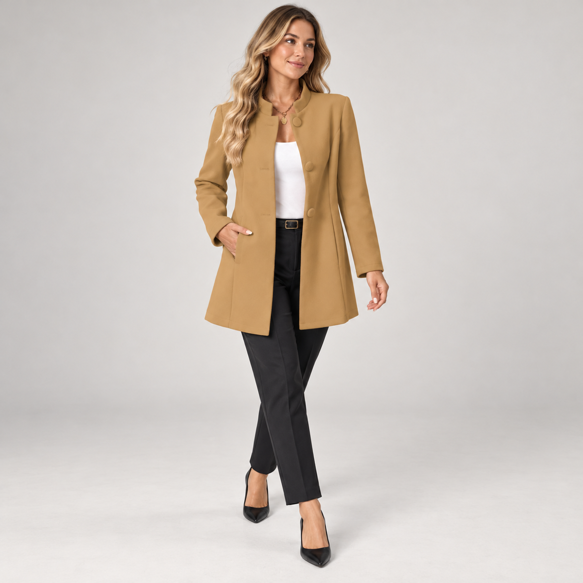 Long women’s collarless open-front blazer, worn by a female model in a walking pose