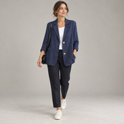 Women's loose-fit blazer with two buttons and roll-up sleeves, worn by a female model in a walking pose