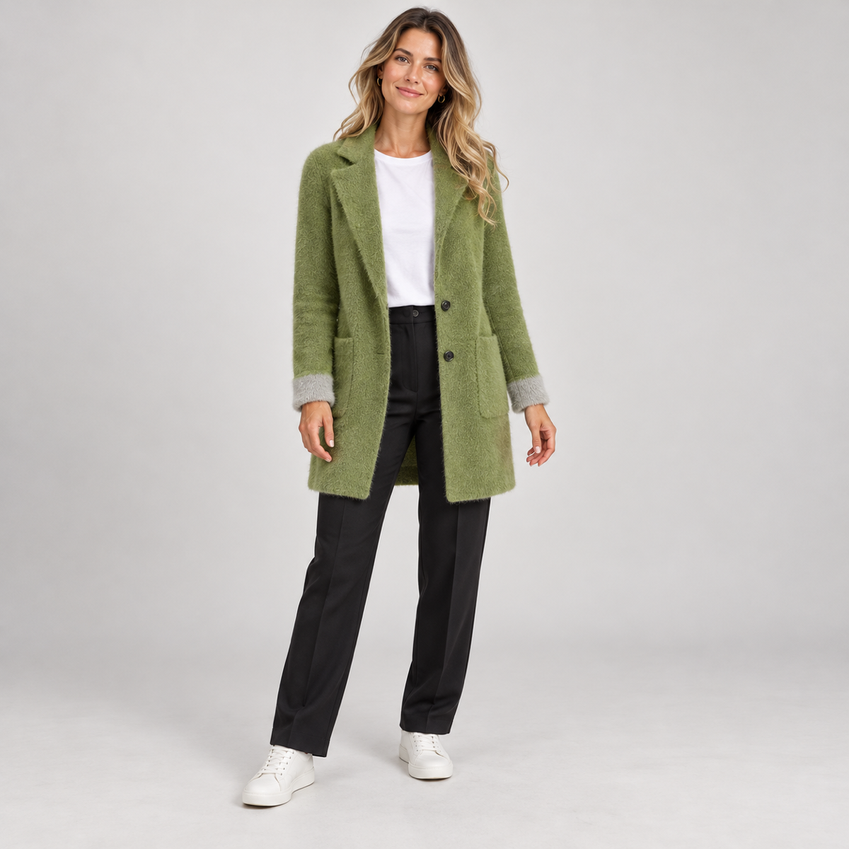 Women's long green oversized blazer with pockets, worn by a female model, front view