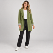 Women's long green oversized blazer with pockets, worn by a female model, front view