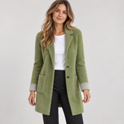 Women's long green oversized blazer with pockets, worn by a female model, close-up
