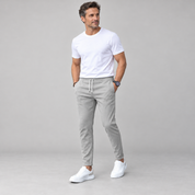 Men's classic tailored trousers with a neat fit, worn by a male model, angled front view
