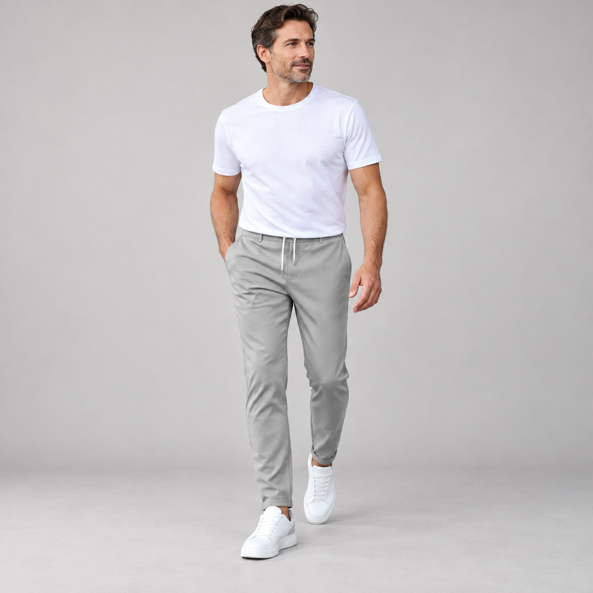 Men's classic tailored trousers with a neat fit, worn by a male model in a walking pose