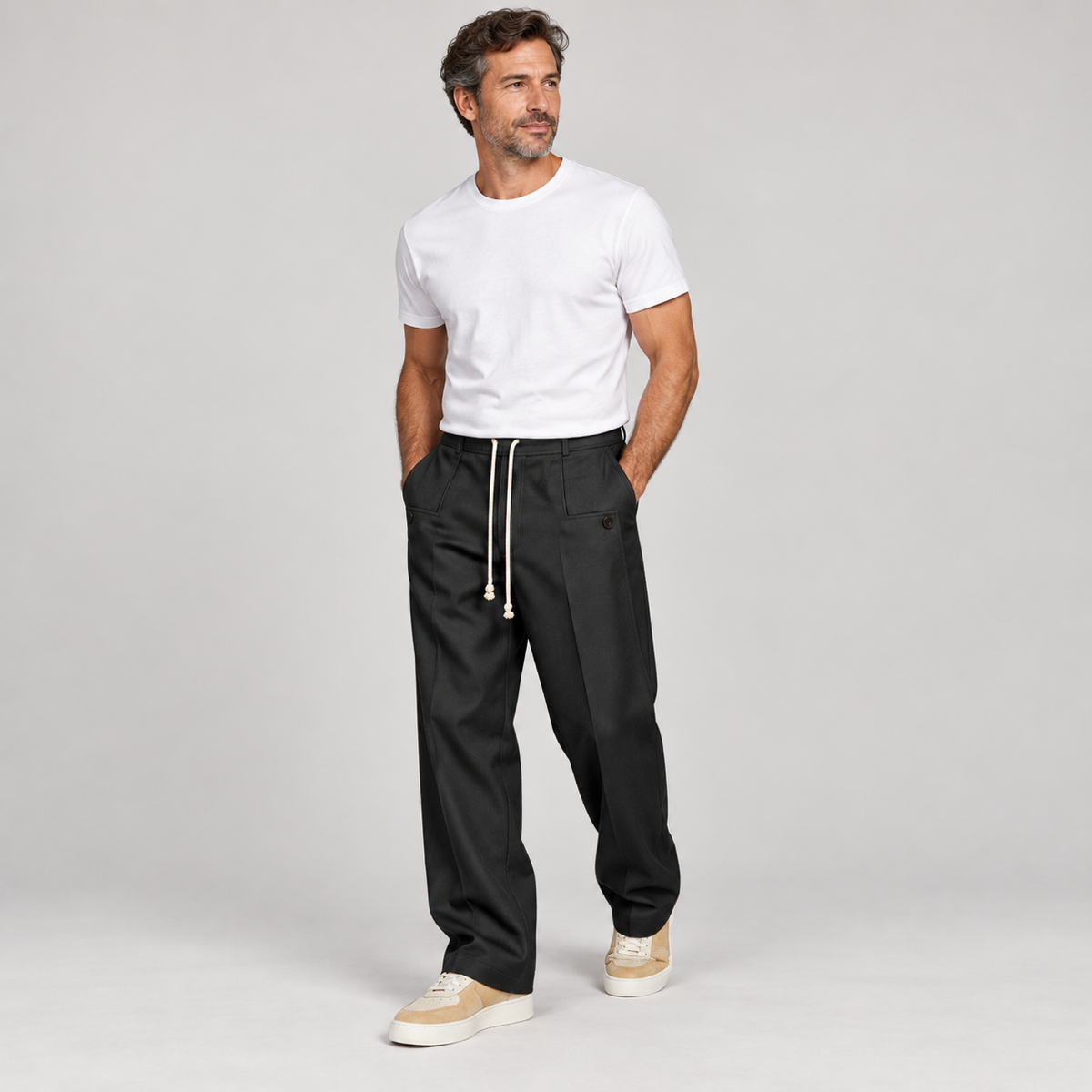Men's trousers with a drawstring and a slim fit, worn by a male model, angled front view