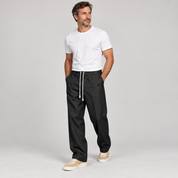 Men's trousers with a drawstring and a slim fit, worn by a male model, angled front view