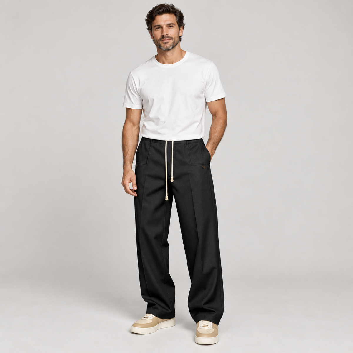 Men's trousers with a drawstring and a slim fit, worn by a male model, close-up