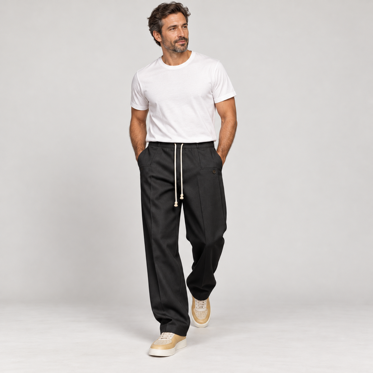 Men's trousers with a drawstring and a slim fit, worn by a male model in a walking pose