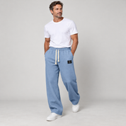 Men's wide-leg trousers with a drawstring and deep pockets, worn by a male model, angled front view