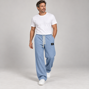 Men's wide-leg trousers with a drawstring and deep pockets, worn by a male model in a walking pose