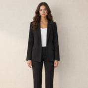 A model wearing a slim-fit black women's blazer, front view
