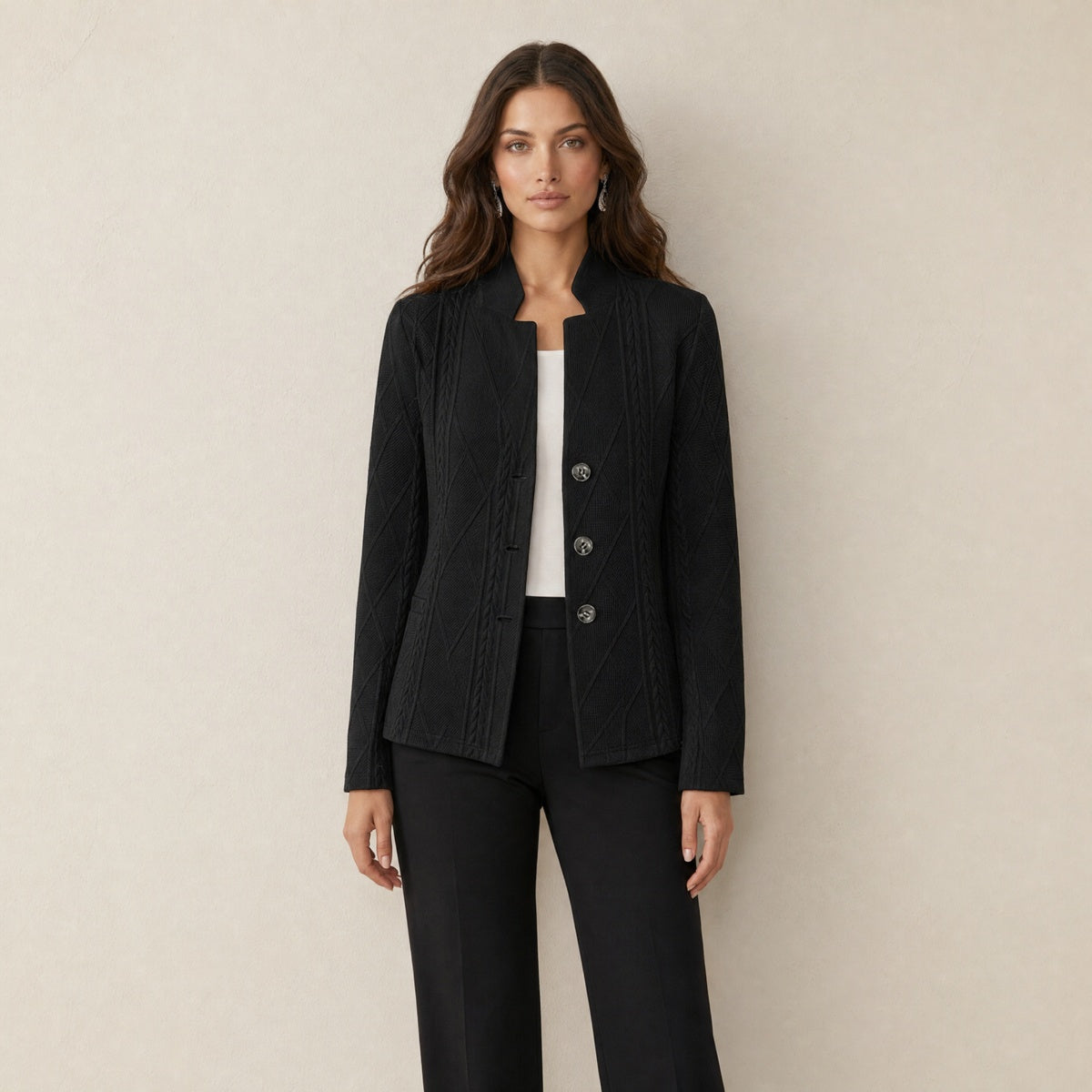 A model wearing a black women's blazer with a cable-knit pattern, front view