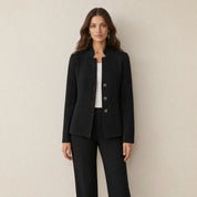 A model wearing a black women's blazer with a cable-knit pattern, front view