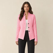 A model wearing a light pink women's blazer with a cable-knit pattern, front view