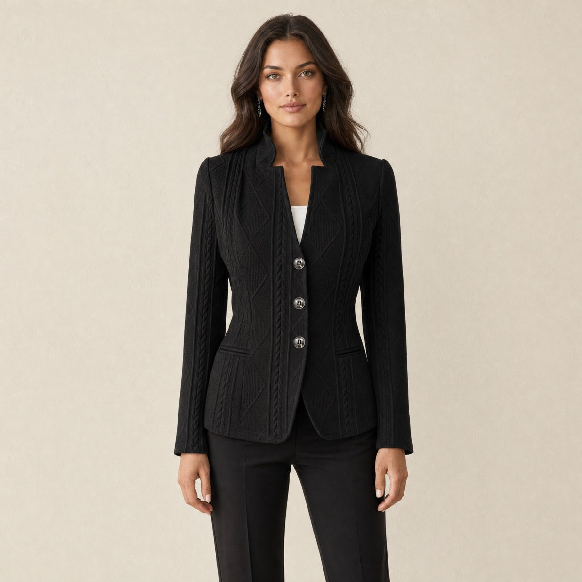 A model wearing a textured black women's blazer with a stand collar, front view