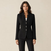 A model wearing a textured black women's blazer with a stand collar, front view