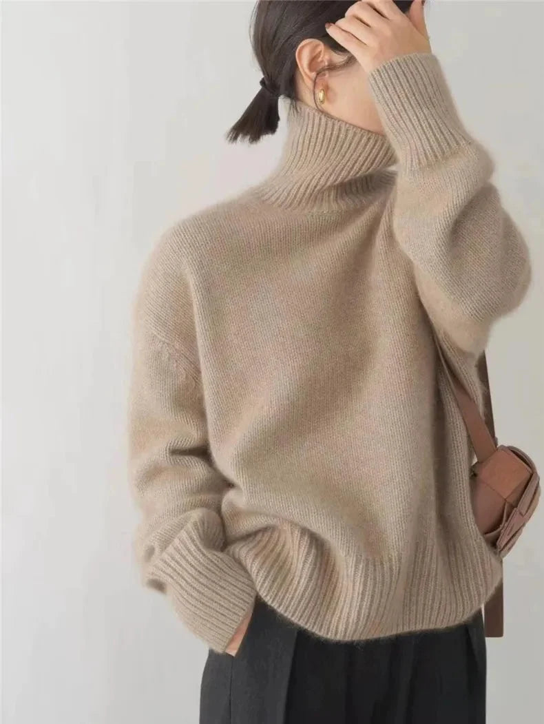 An oversized beige knitted roll-neck jumper with long sleeves