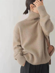 An oversized beige knitted roll-neck jumper with long sleeves