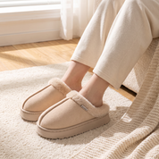 Warm beige women's slippers, worn at home