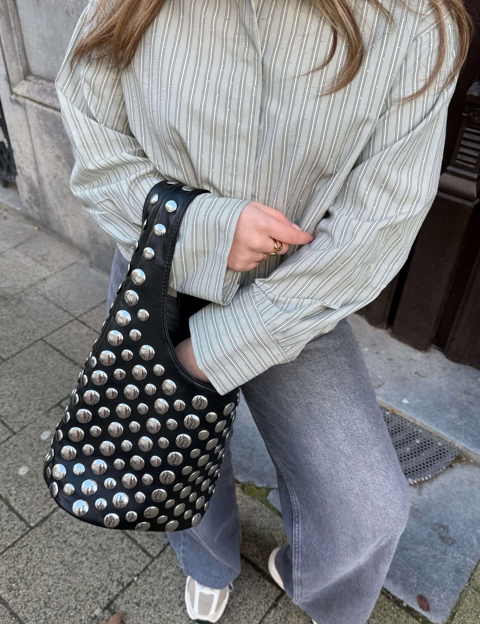 Women's studded faux leather bucket bag with drawstring