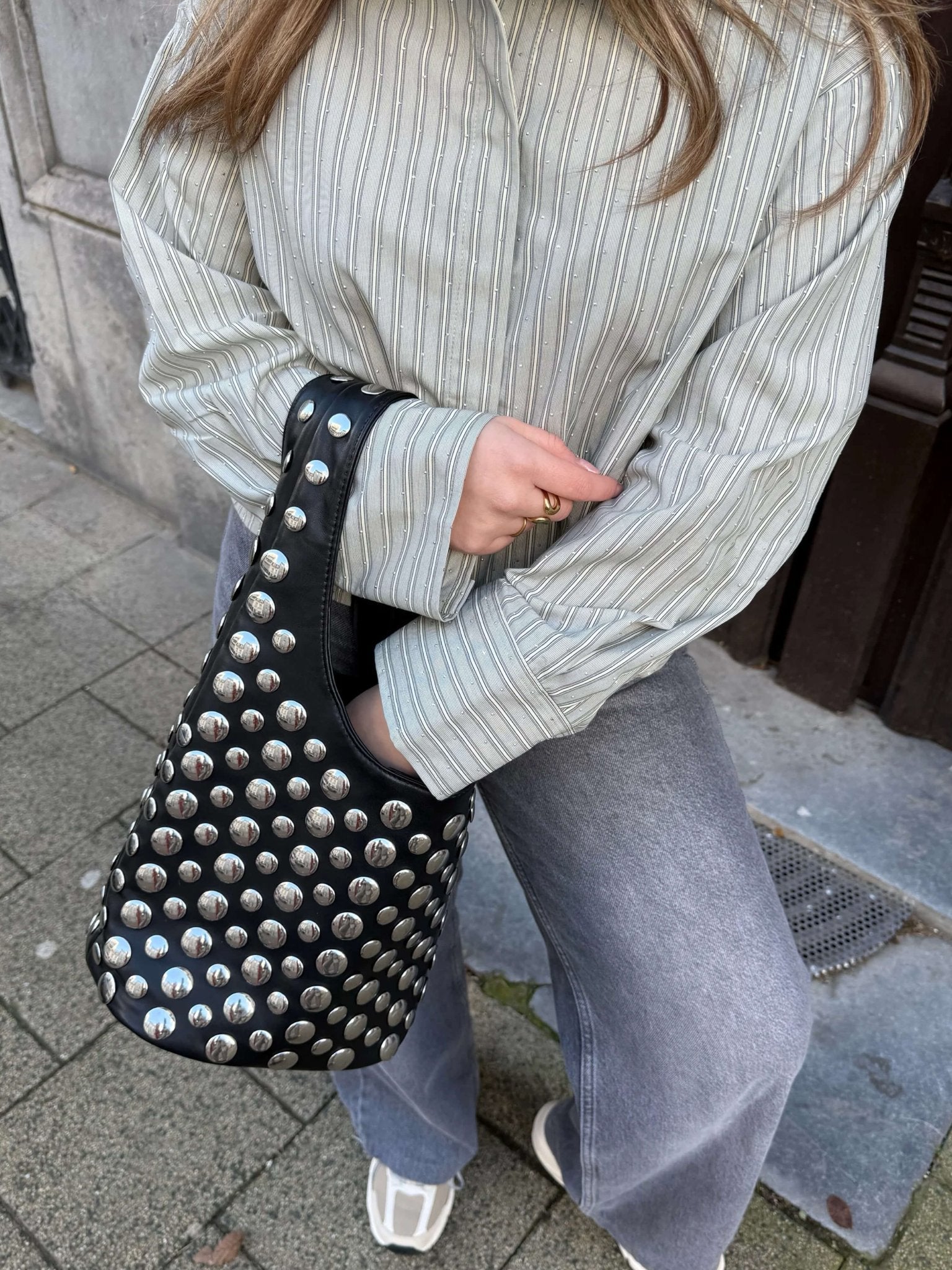 Women's studded faux leather bucket bag with drawstring