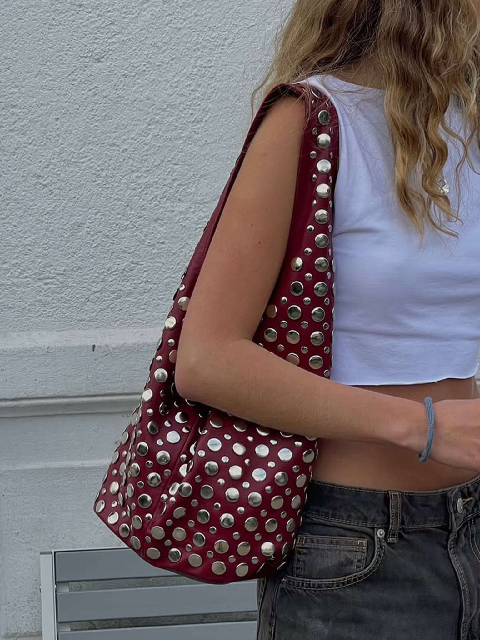 Women's studded faux leather bucket bag with drawstring