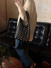 Women's studded faux leather bucket bag with drawstring