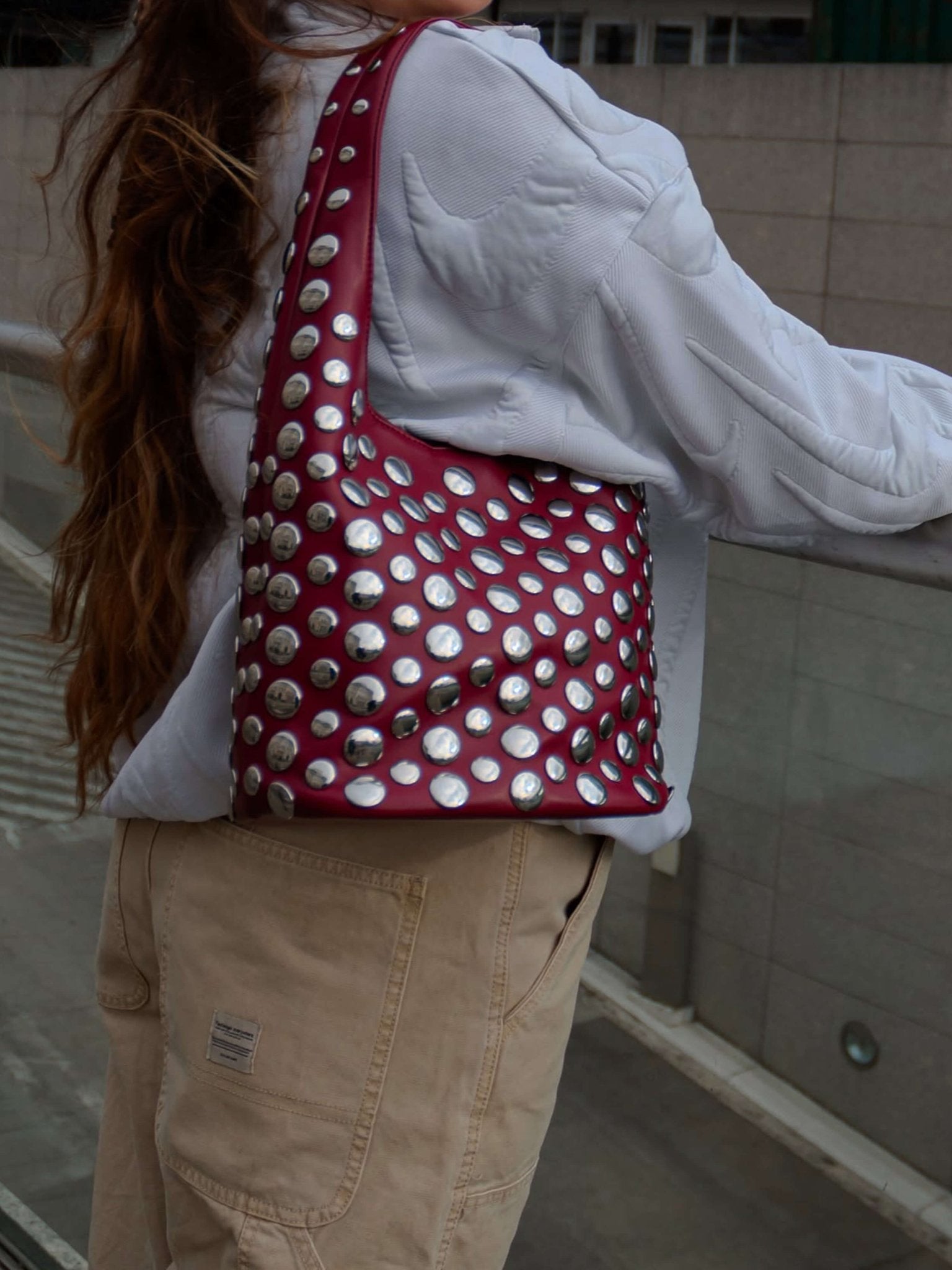 Women's studded faux leather bucket bag with drawstring
