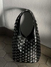 Women's studded faux leather bucket bag with drawstring