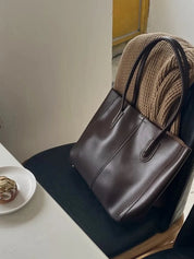 Women's large faux leather tote bag with zip and buckle
