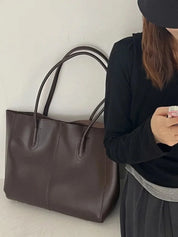 Women's large faux leather tote bag with zip and buckle