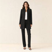 A model wearing a long black women's collarless blazer, front view