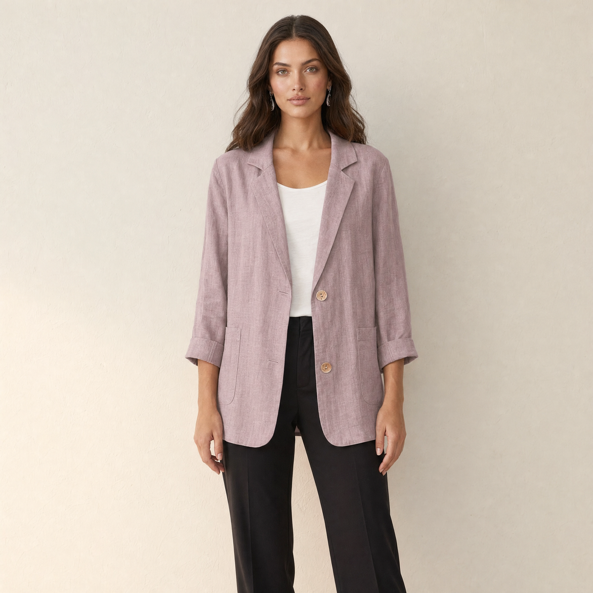 A model wearing a loose-fitting pink women's blazer, front view