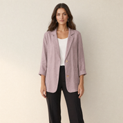 A model wearing a loose-fitting pink women's blazer, front view