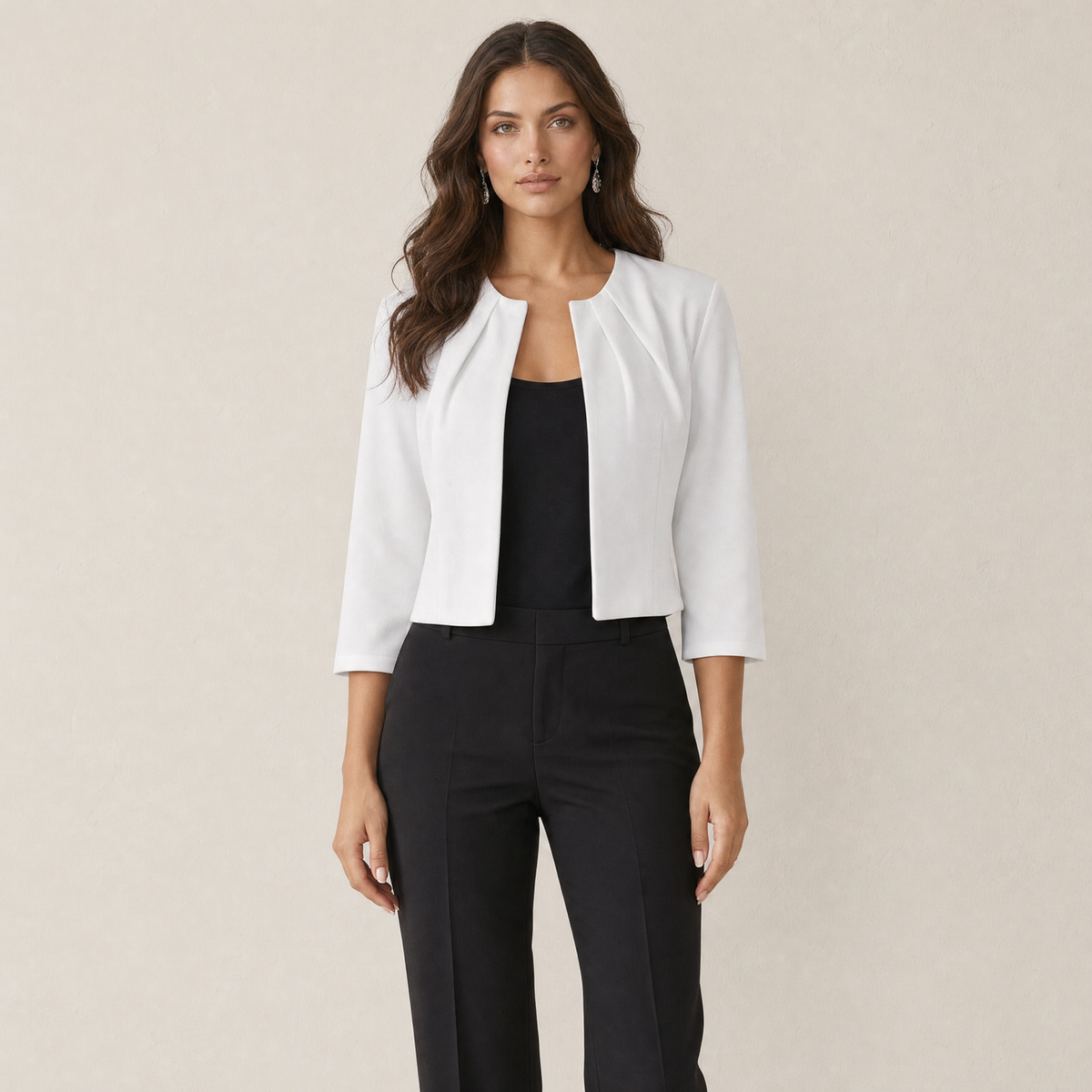A model wearing a cropped white women's blazer with three-quarter sleeves, front view