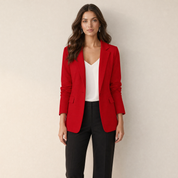 A model wearing a tailored red women's blazer with lapels, front view