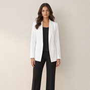 A model wearing a slim-fit white women's blazer, front view