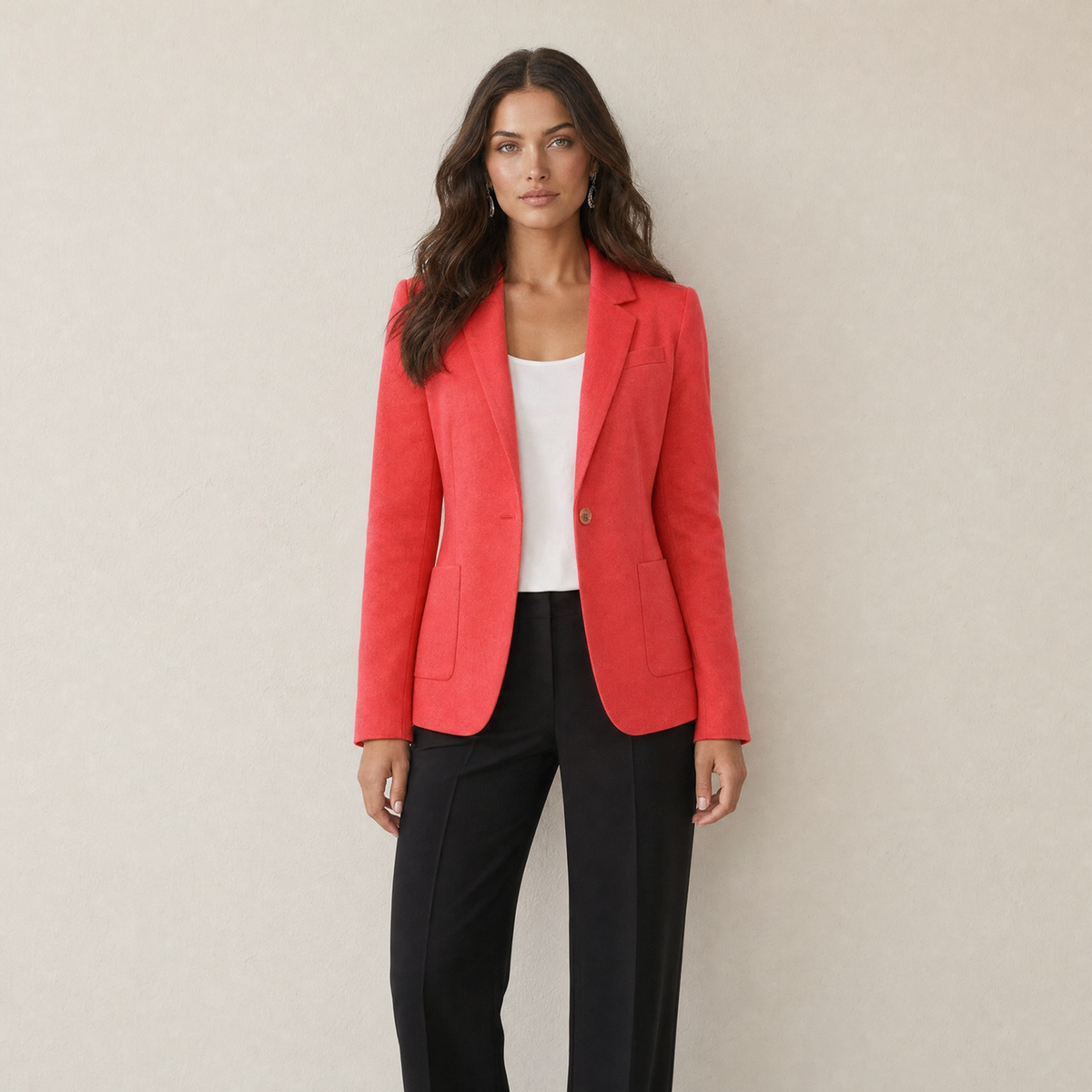 A model wearing a tailored red women's blazer with one button, front view