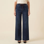 Women's dark wash wide leg jeans with brown drawstring and contrast stitching, front detail
